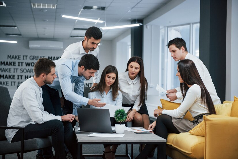 guy-shows-document-girl-group-young-freelancers-office-have-conversation-working_146671-13569 - Orca Insurance Group Business Owner Policy